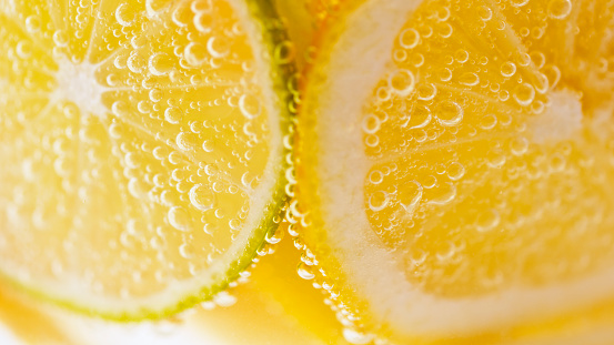 Close-up of carbonated water with citrus fruits