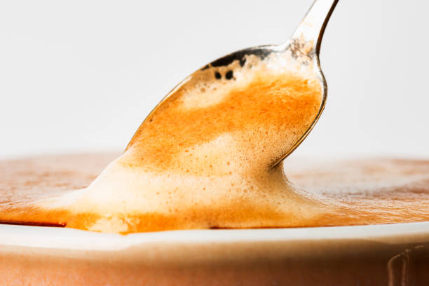 istock Cup latte coffee with spoon of foam 1369531799