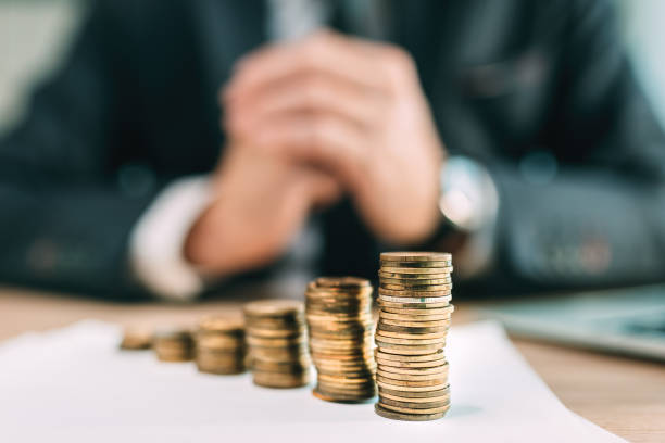 istock Retirement saving plant concept, businessman with coin stack on office desk 1369531851