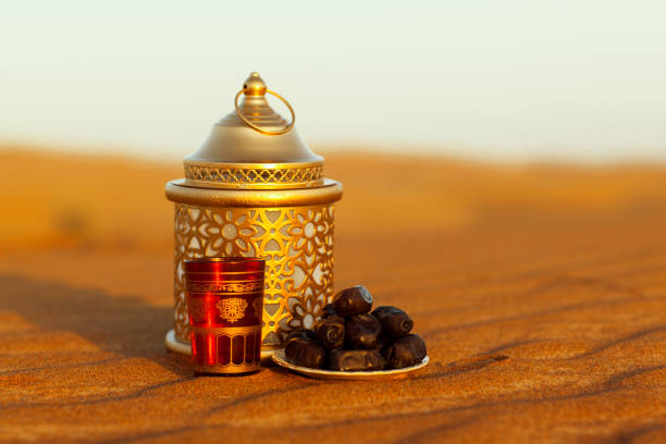 istock Lantern, cup and dates in the desert at a beautiful sunset, 1369534601