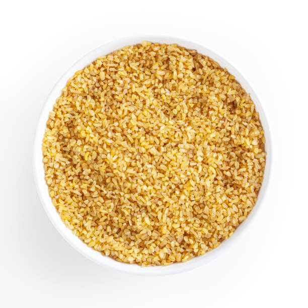 Dried bulgur in white bowl isolated on white background with clipping path Dried bulgur in white bowl isolated on white background with clipping path bulgur wheat stock pictures, royalty-free photos & images