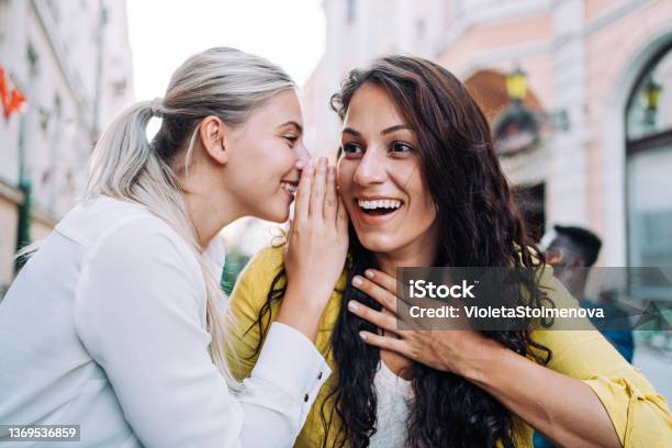 Two Female Young Friends Sitting In City Cafe And Gossiping Stock Photo - Download Image Now