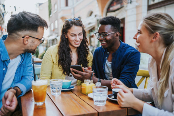 istock Young friends enjoying a coffee together. 1369536888