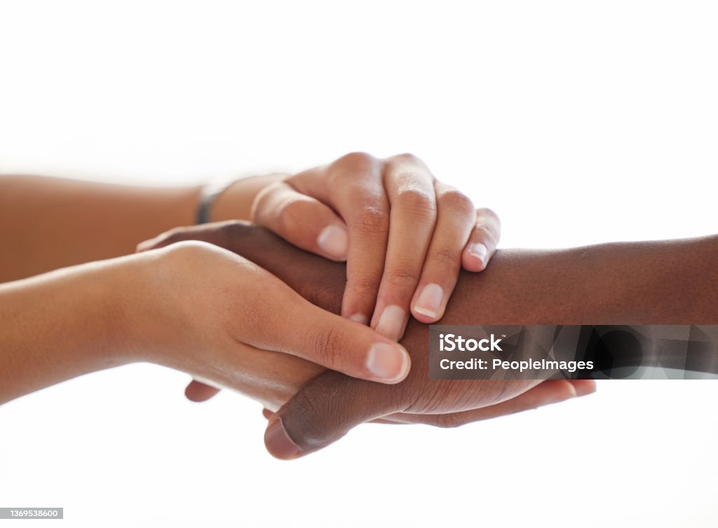 Shot of an unrecognisable man and woman holding hands a light background Hold onto me, we'll make it through Holding Hands Stock Photo