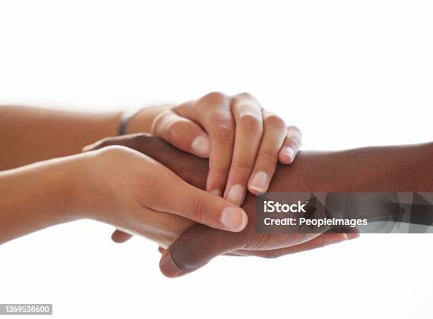 Shot Of An Unrecognisable Man And Woman Holding Hands A Light Background Stock Photo - Download Image Now