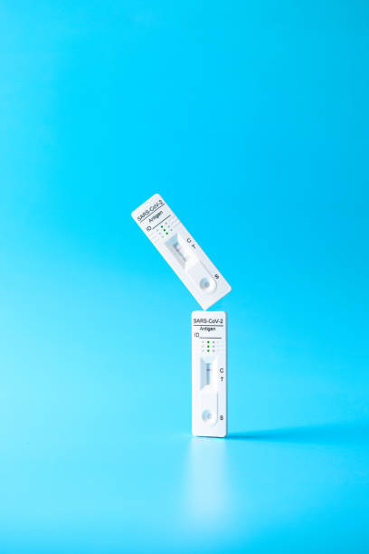 istock Two Covid-19 Test rapid antigen diagnostic test device with negative and positive result on blue background.Levitation still life 1369538717