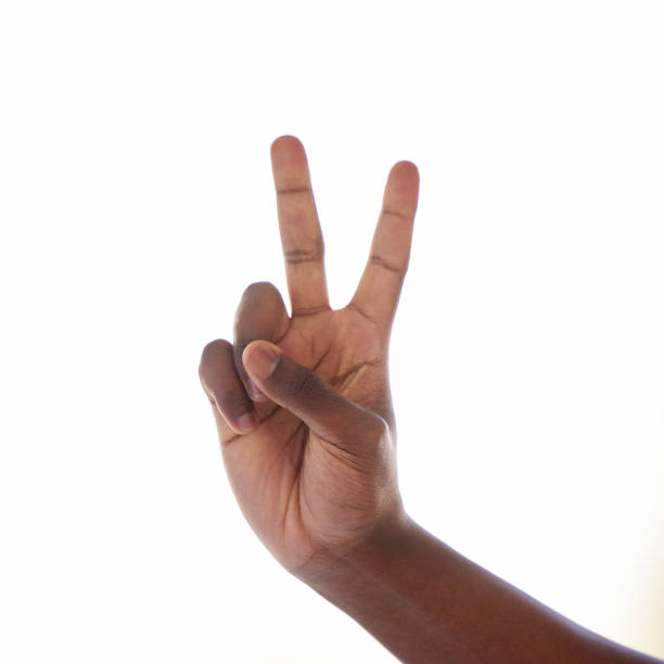istock Studio shot of an unrecognisable man making a peace sign against a white background 1369539506