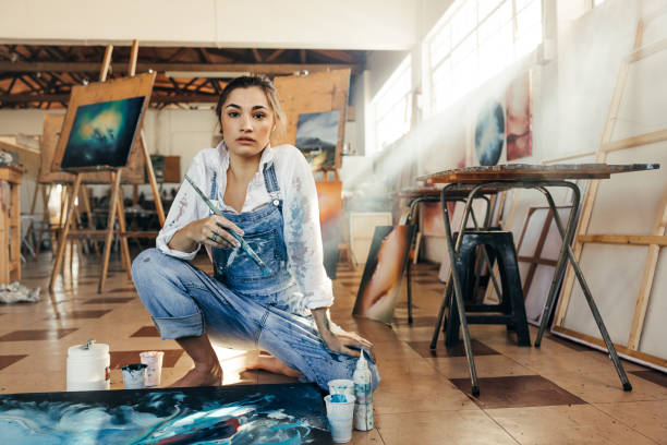 istock Inventive female painter looking at the camera 1369542996