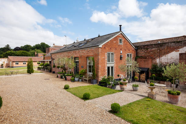 Luxurious Country Home Old farm outbulding converted into luxurious countryside home within charming landscaped gardens pebble driveway stock pictures, royalty-free photos & images