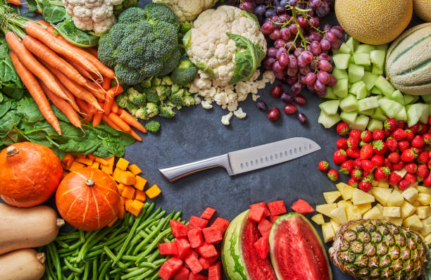istock lots of fruit and vegetable with a knife in the middle 1369548468