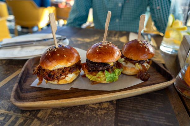 istock 3 different kind of burger tasting in a restaurant 1369549040