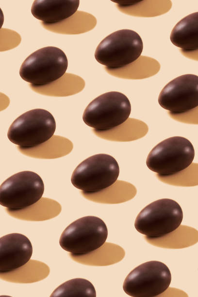 istock Chocolate Eggs in a Row on Yellow Background 1369549121
