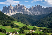 The great rocky walls of the Odle Dolomites Group above the village of Santa Maddalena in Val di Funes.