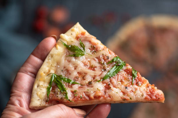istock Piece of pizza with marijuana 1369551044