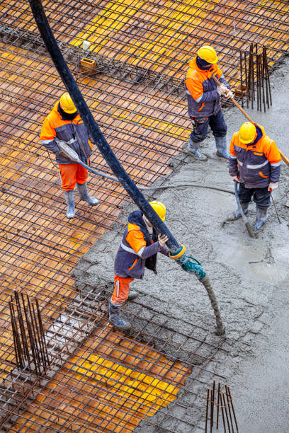 istock Concrete pouring on the construction site. 1369551063