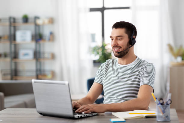 istock man with headset and laptop working at home 1369552527