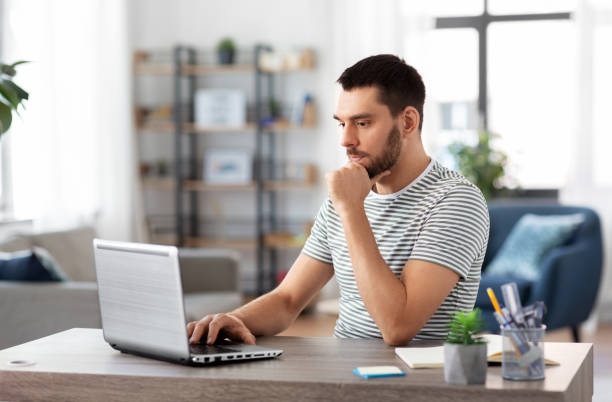 istock man with laptop working at home office 1369553750