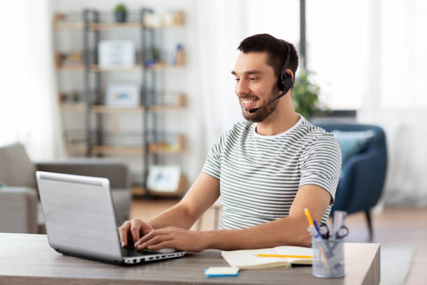 istock man with headset and laptop working at home 1369554918