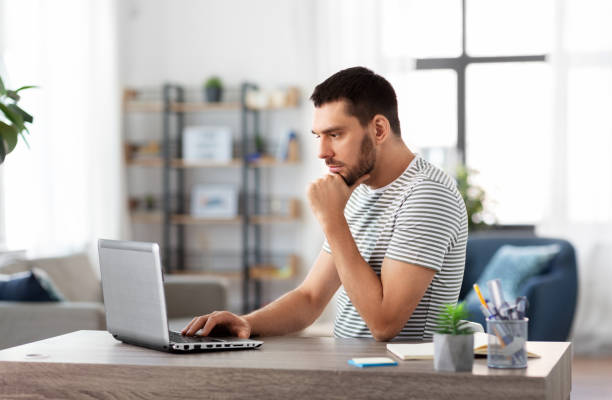 istock man with laptop working at home office 1369555653