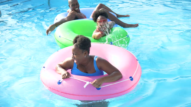 African-American family floating on lazy river