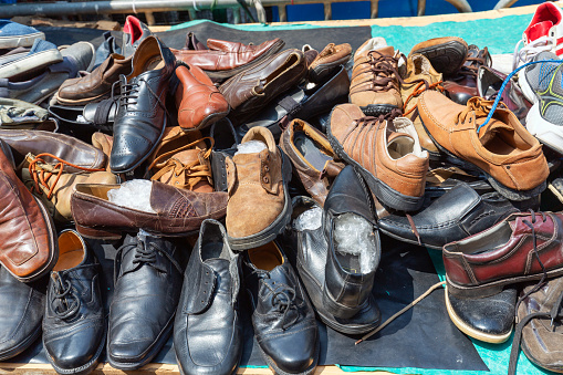 Old shoes are sold at the street market in Colombo