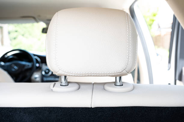 istock Headrest in modern luxury comfortable car with the beige perforated leather 1369558946