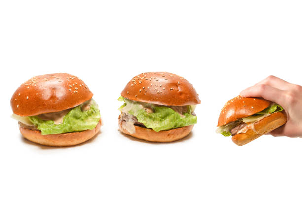 istock Hamburger in woman hands isolated on a white background. 1369559540