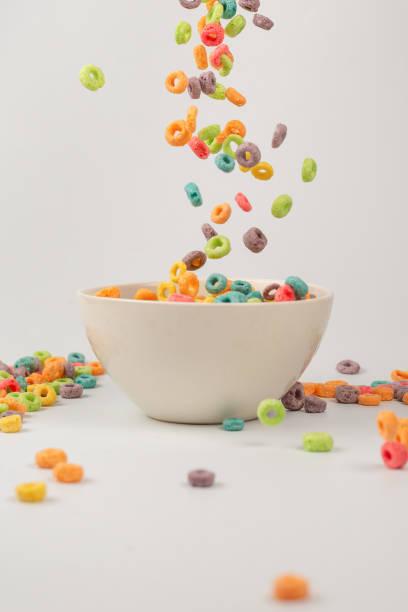 istock Colorful cereal box for morning breakfast. Corn flakes falling to the white bowl. Motion. 1369559561