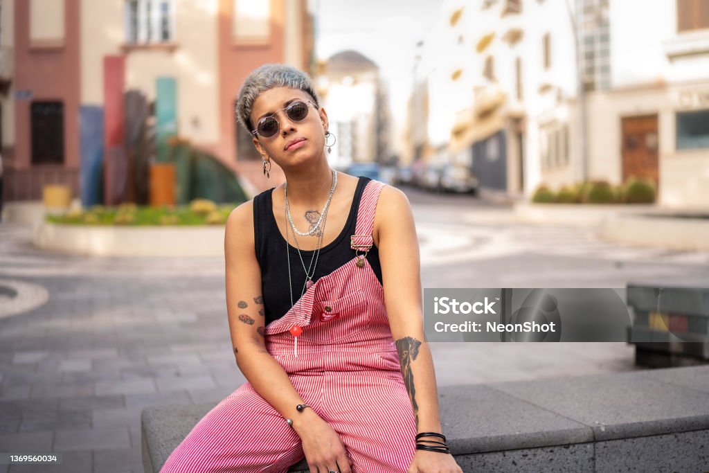 Young Modern Fashionable Girl With Short Hair Wearing Sunglasses And A Lot  Of Jewelry City Street Style Stock Photo - Download Image Now - iStock