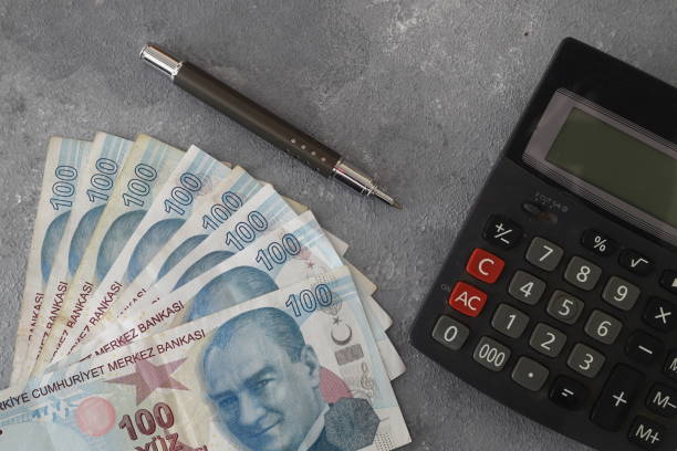istock Turkish lira with a Calculator and a Pen 1369560715
