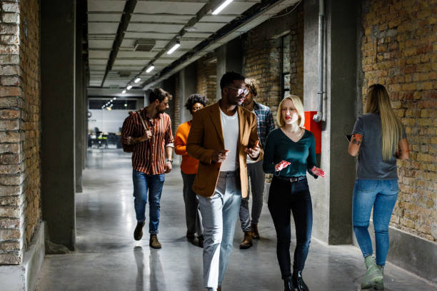 istock Young and smart workers are walking down the hall, going home from hard work. 1369560909