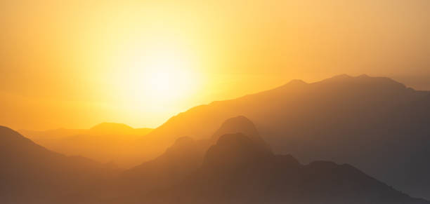 istock natural landscape - misty mountains at sunset 1369561115