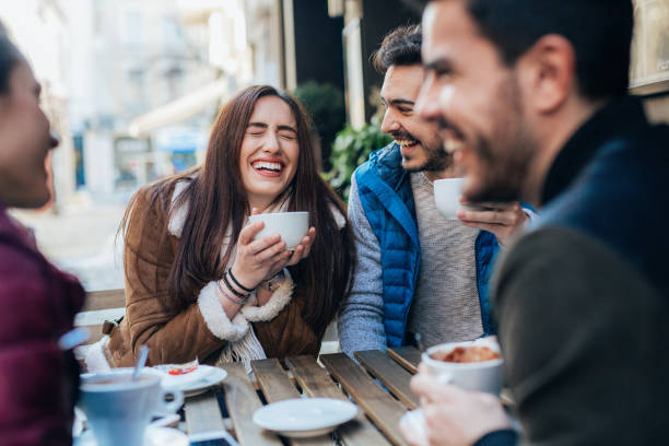 istock Friends talking and laughing in a cafe 1369561388