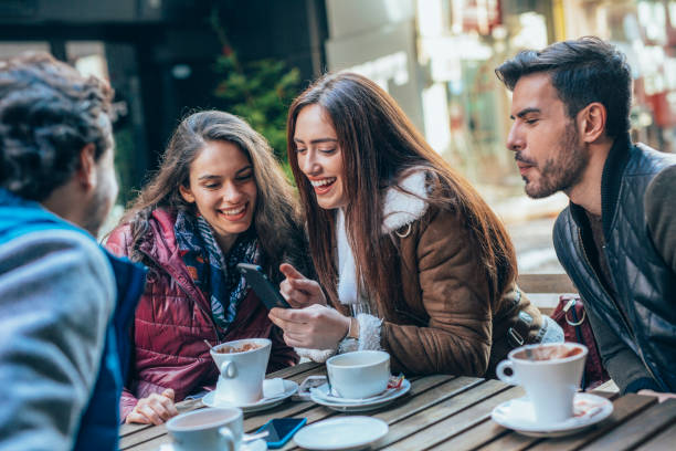 istock Friends talking and laughing in a cafe 1369561390