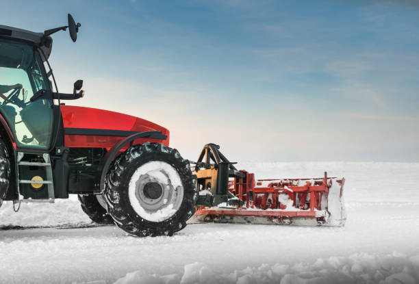 istock Tractor cleaning snow in field 1369564182