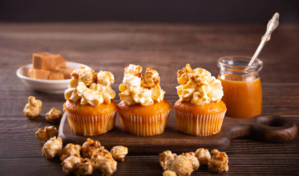 istock Homemade cupcakes with caramel popcorn and whipped cream cheese 1369564703