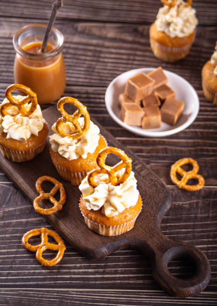 istock Homemade cupcakes with caramel syrup and whipped cream cheese 1369564738