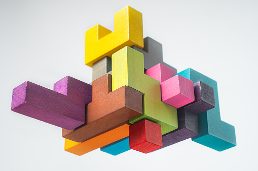 Abstract construction from wooden blocks. Colorful wooden building blocks. The concept of logical thinking.