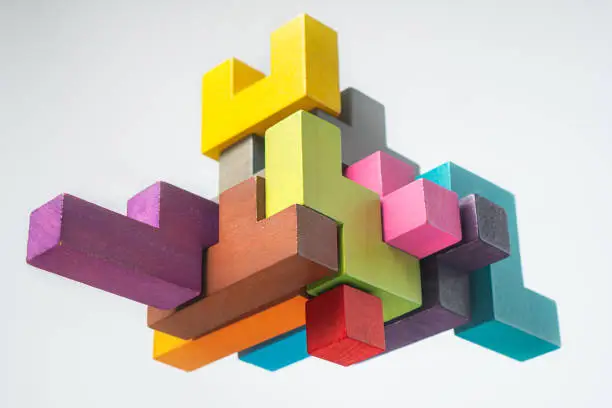 Photo of Abstract construction from wooden blocks. The concept of logical thinking.