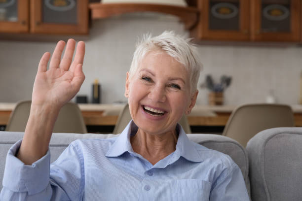 istock Happy excited senior retired lady enjoying video call talk 1369567623