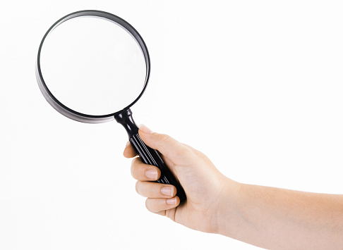 Woman searching with a magnifying glass.