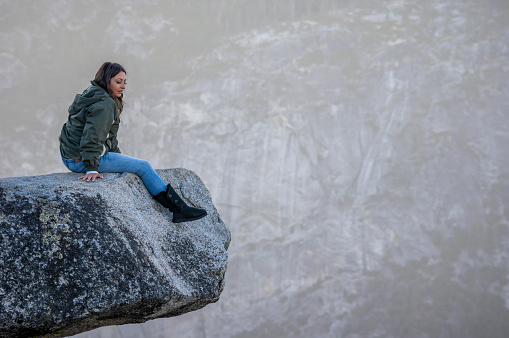 October 8, 2018 - Yosemite, United States: tourist woman on a cliff in Yosemite National Park, California, USA