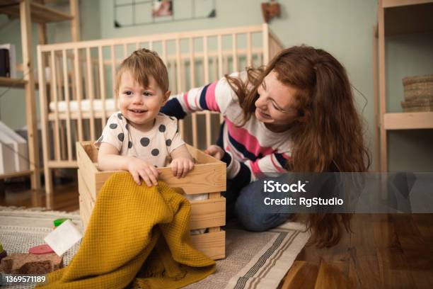 Young Woman Playing With Her Cute Baby In The Box Stock Photo - Download Image Now - Small, Mother, People