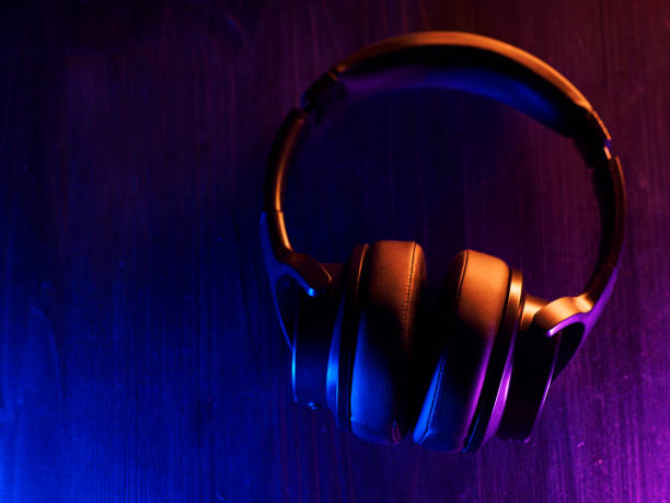 istock overhead wireless stylish headphones on a dark background with backlight 1369571275
