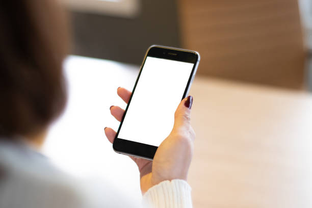 istock Smartphone mockup image of a woman's hand holding mobile phone with blank screen. 1369572122