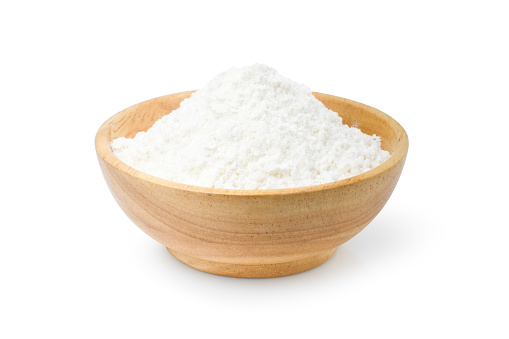 White rice flour in wooden bowl isolated on white background. Clipping path.