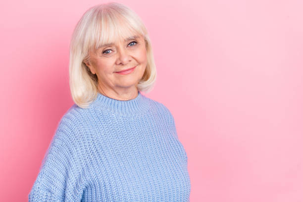 istock Portrait of attractive kind nice cheery grey-haired woman wearing pullover copy space isolated over pink pastel color background 1369572603