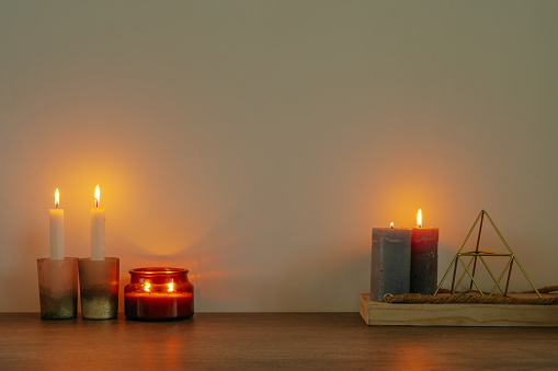 Candles on the wooden table with blank space for text. Cozy home decor. Eco friendly concept.
