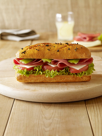 Delicious fresh sandwich on wooden table