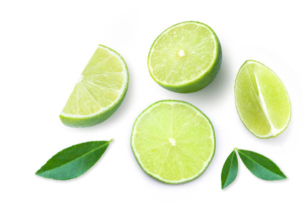 Lime Slice of green lime fruit with green leaf isolated on white background. Top view. Flat lay. Copy space for text. lime stock pictures, royalty-free photos & images